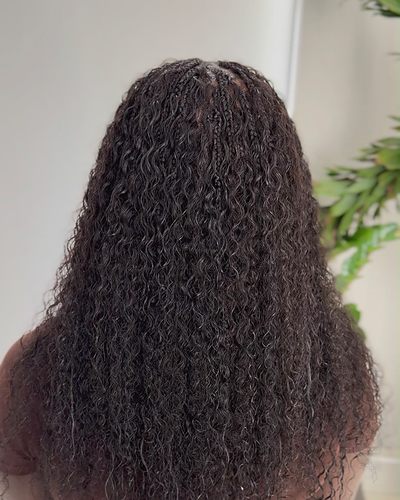 Boho knotless braids in dense human curly hair, mid-back length