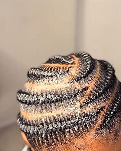 Curved stitch feed-in cornrows with a swirled crown pattern